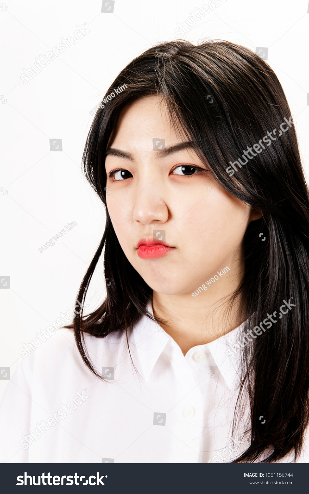 Close-up of a slightly sulky woman's face #1951156744