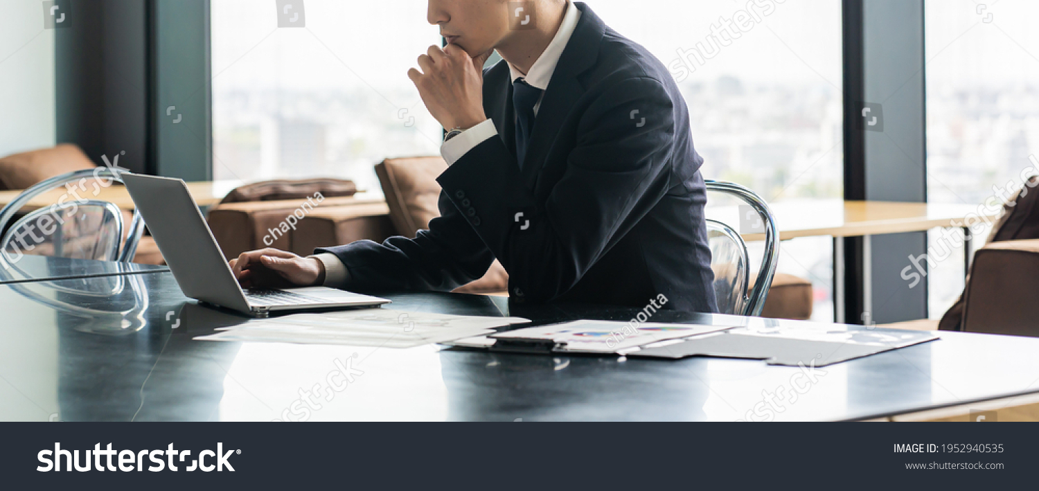 Young Japanese businessman working indoors #1952940535