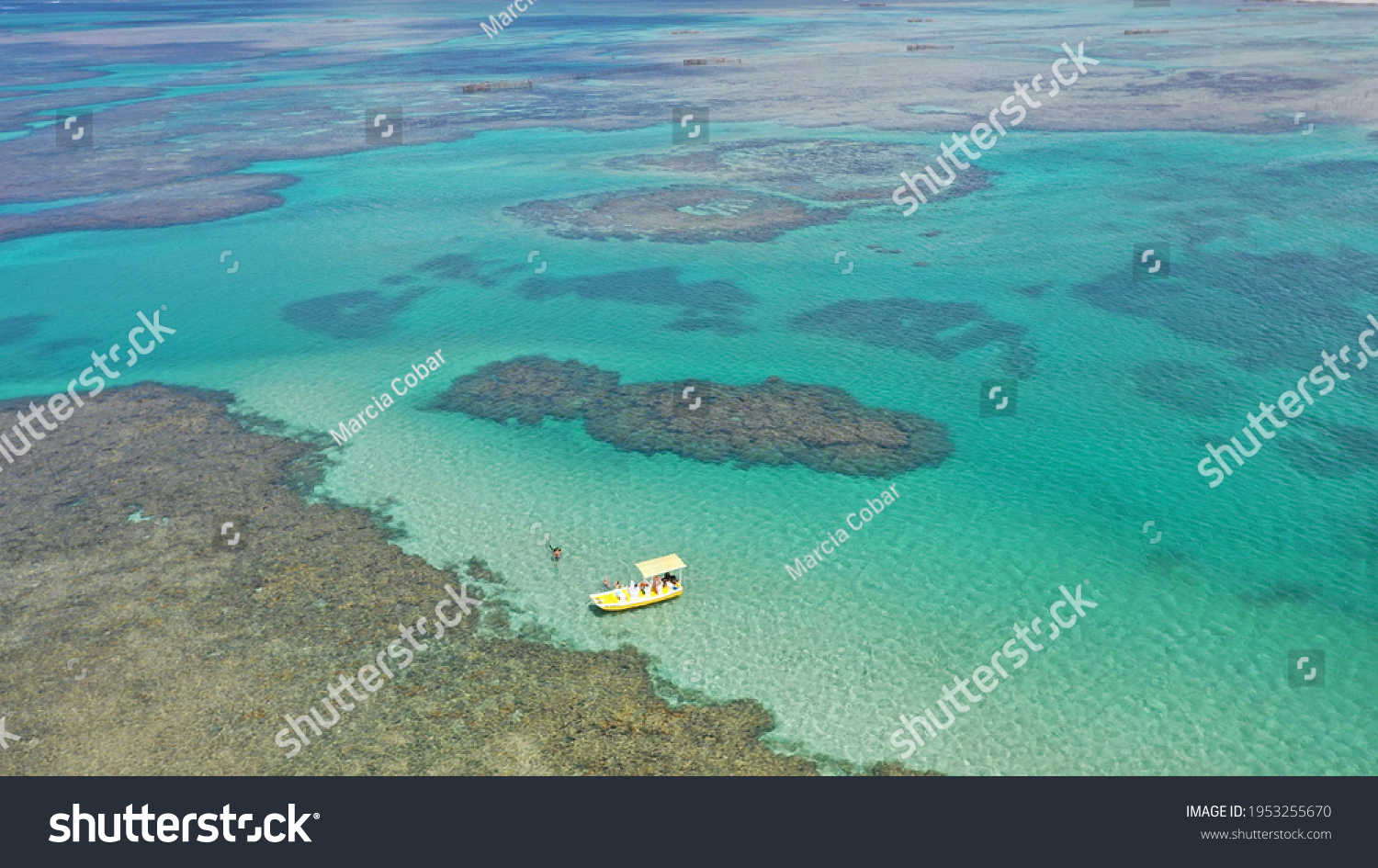Aerial view of a yellow boat near a coral reef in Costa dos Corais near São Miguel dos Milagres, Alagoas, Brazil #1953255670