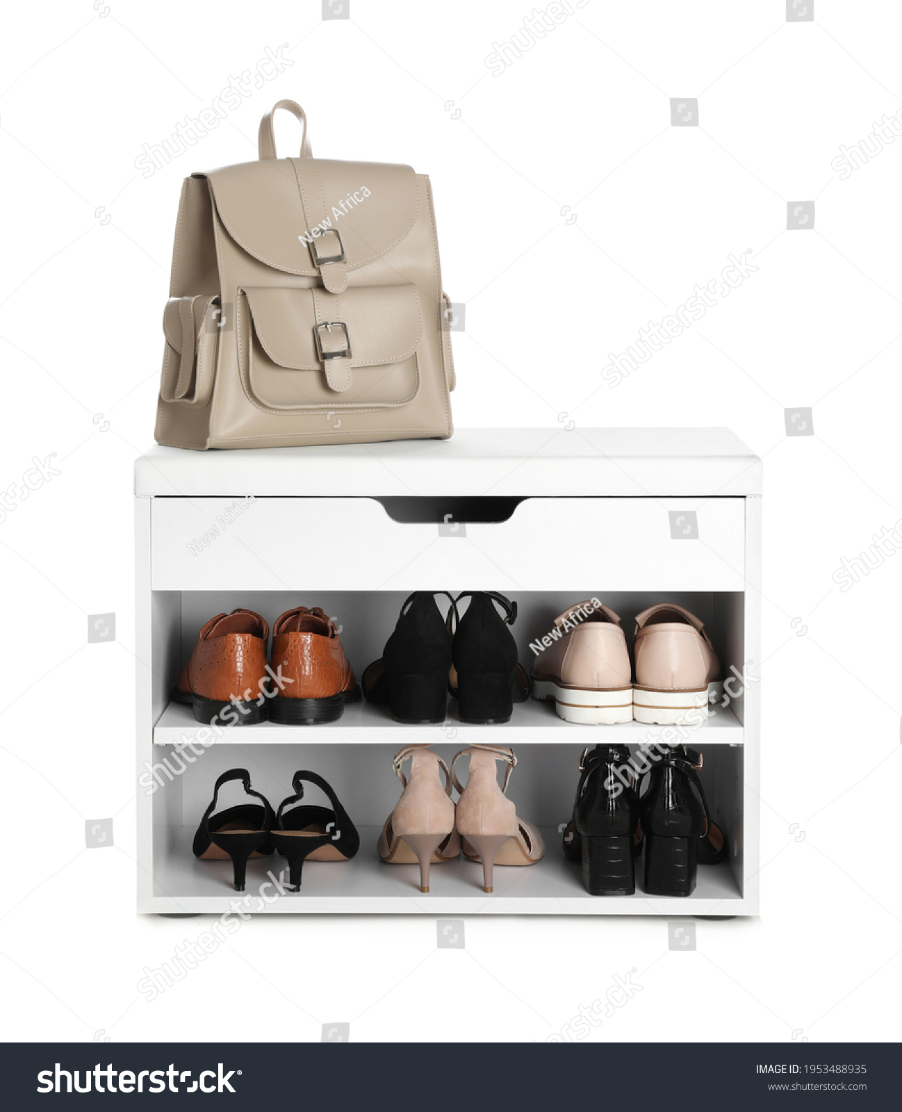 Stylish storage cabinet with different pairs of shoes and backpack on white background #1953488935