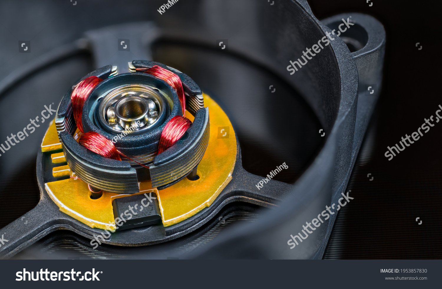 Electric motor rotor with permanent magnet, copper wire inductors and metal ball bearing. Close-up of disassembled computer fan with integrated Hall-effect sensor. Detail of open black plastic cooler. #1953857830