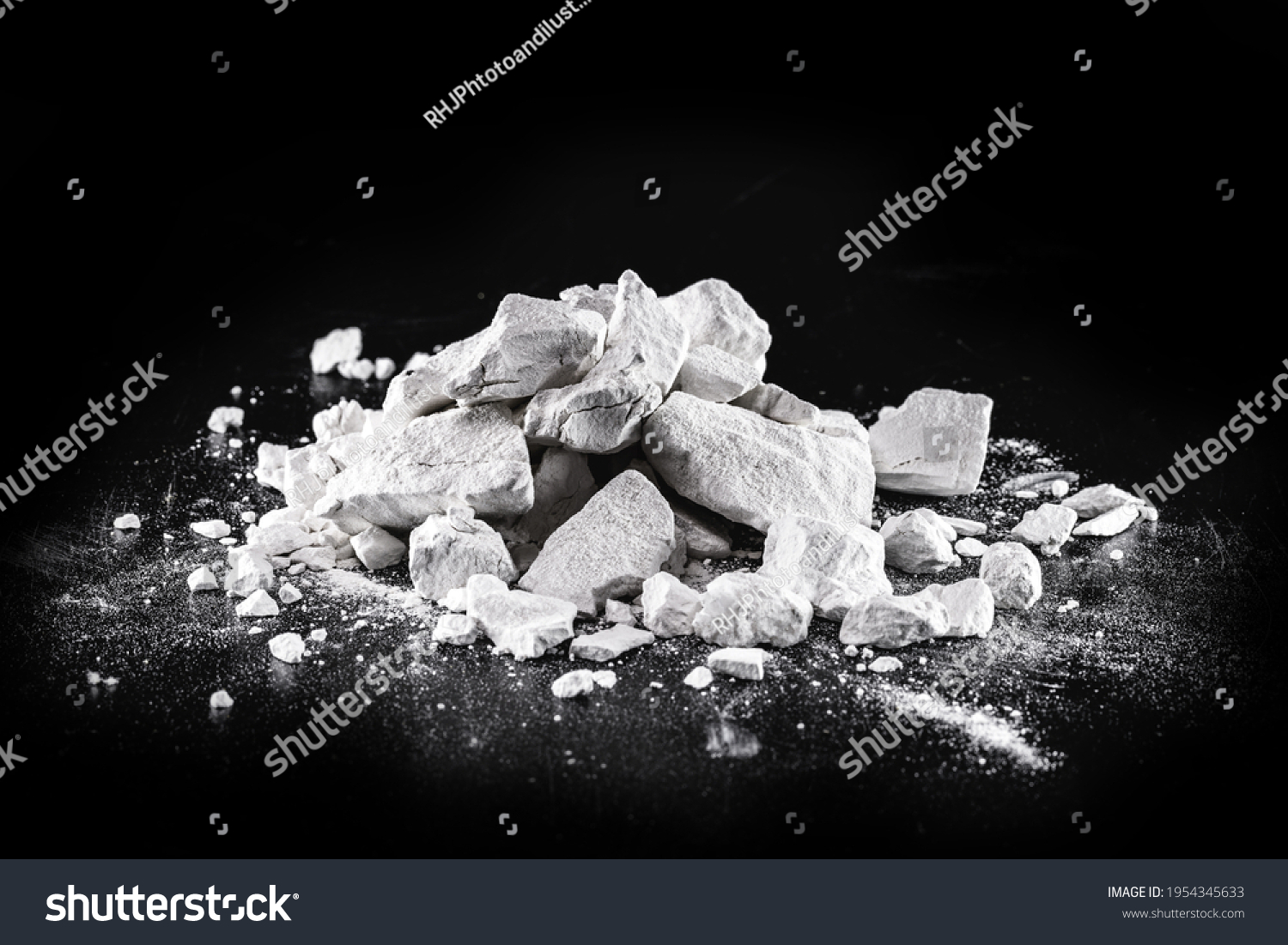 Calcium and Magnesium stones, black background. Called virgin lime or quicklime #1954345633