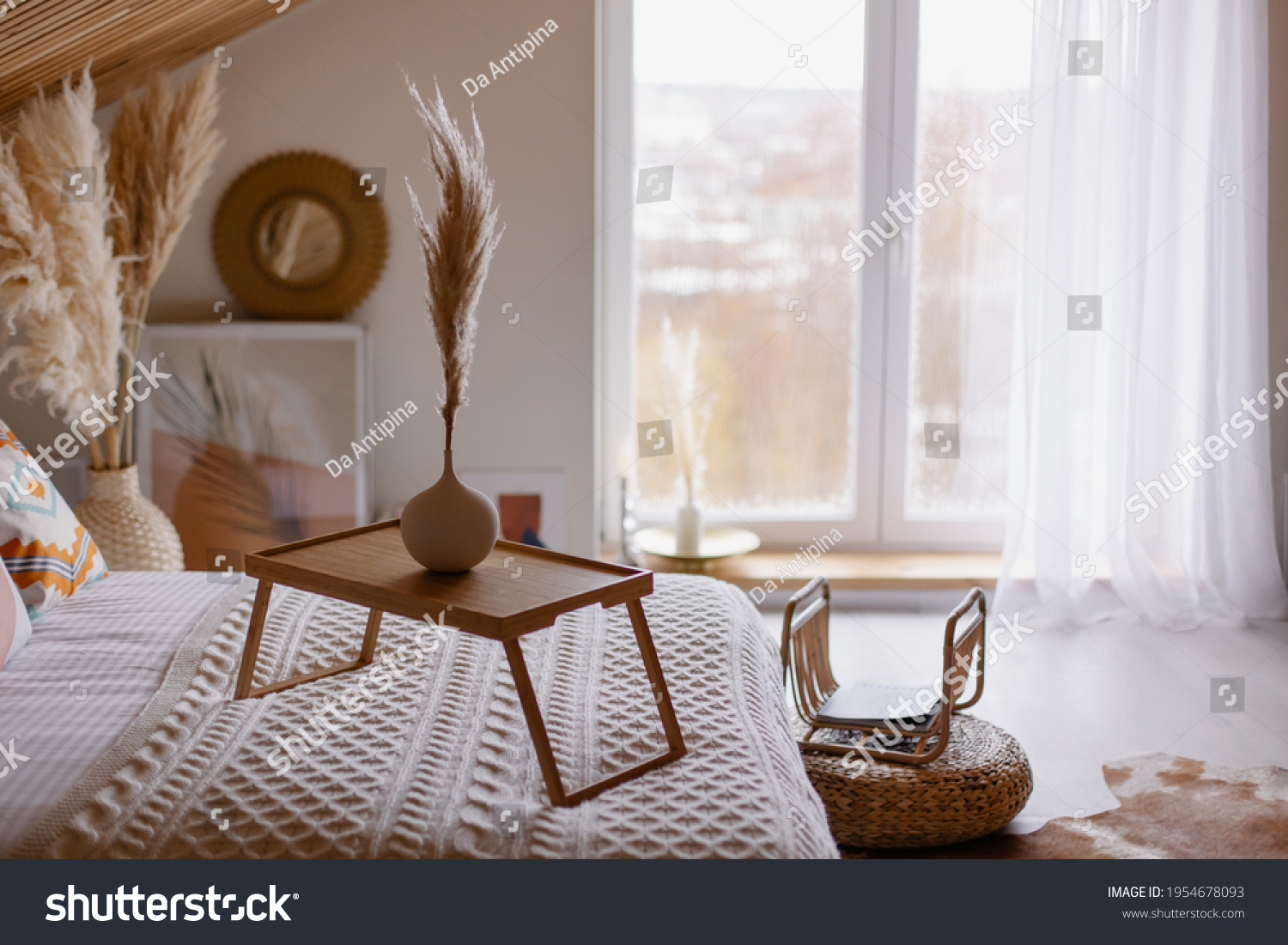 beautiful boho interior details. Pampas grass in a vase. Hygge mood. Cozy morning in the fall. Bedroom in a country house. The bed is covered with a blanket. coffee table. Relax environment #1954678093