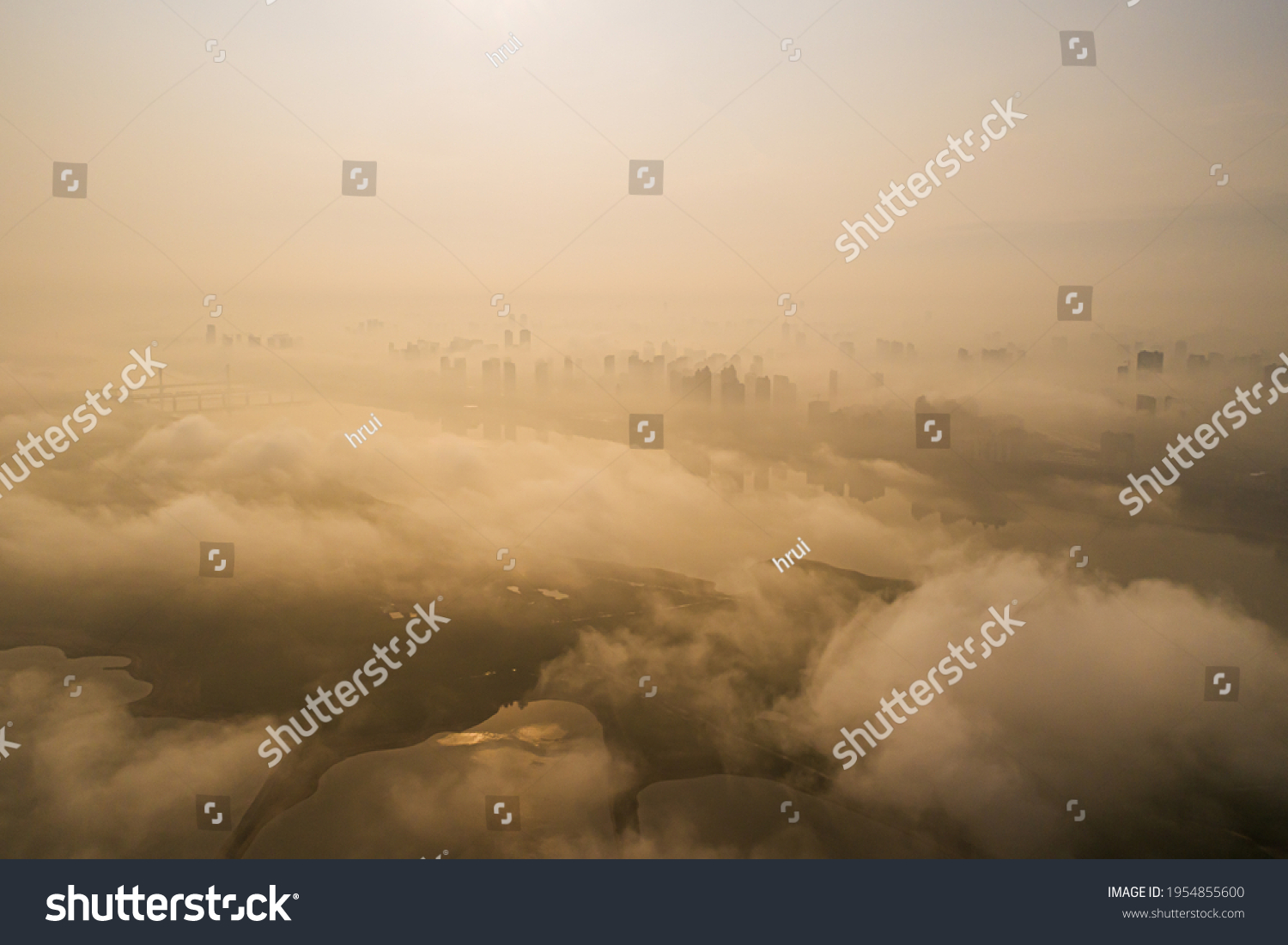 View across Warsaw skyline showing in sunset with smog and dust in the air, Low visibility caused by pollution problem in urban area, Big city in the fog, Fog and smog over Warsaw #1954855600