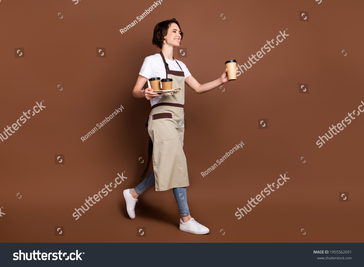 Full length body size view of lovely cheerful girl carrying bringing coffee time break isolated over brown color background #1955562691