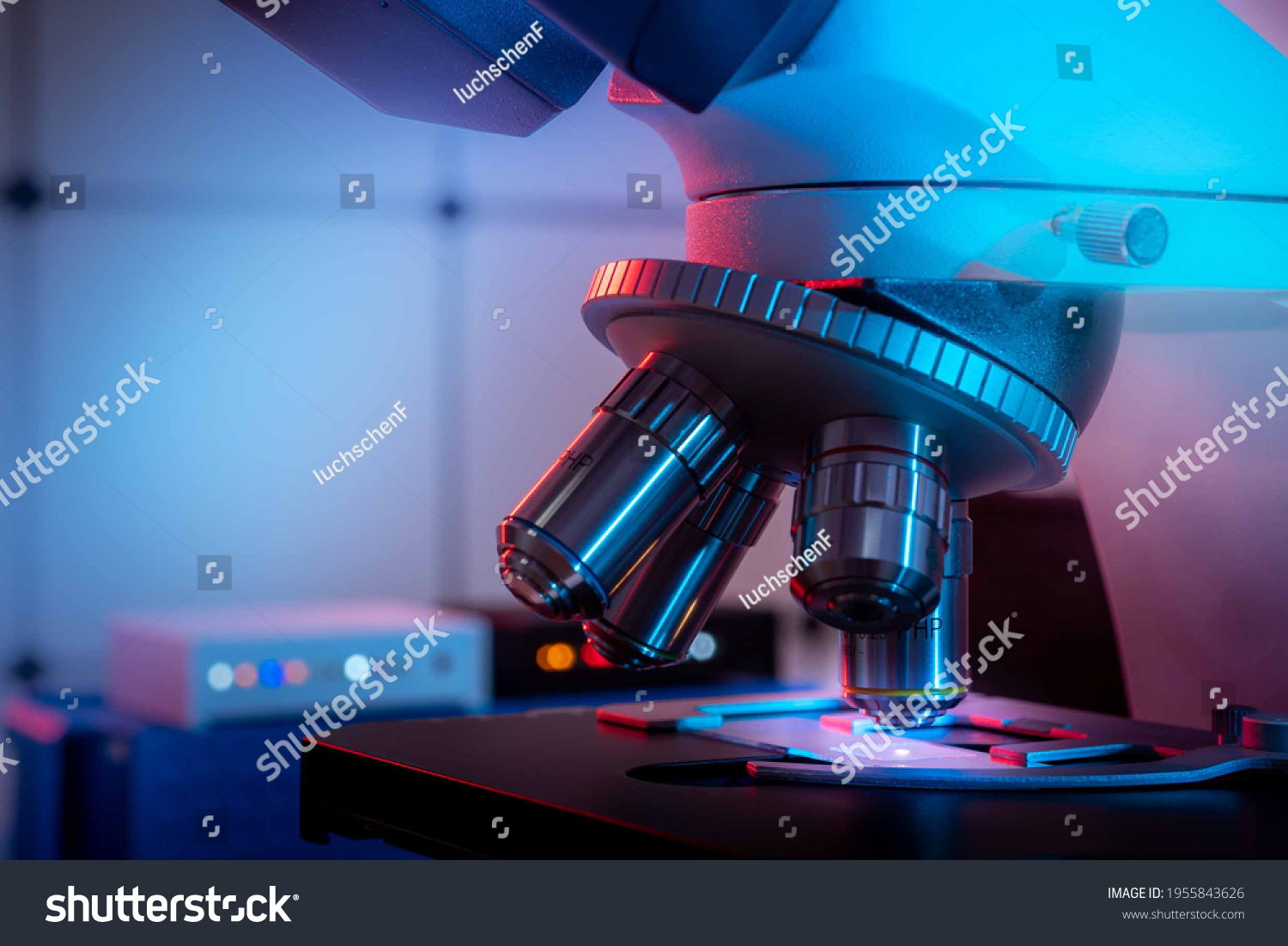 Toned photo of a backlit microscope lens in a science laboratory #1955843626