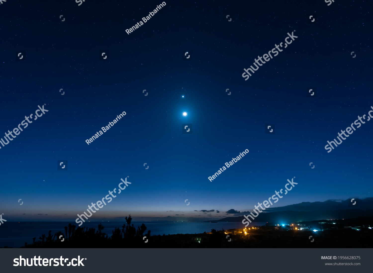 Breathtaking view of a starry sky, Venus, Jupiter and moon line up. Top view of a seashore city before dawn. Iriomote Island, natural world heritage. #1956628075