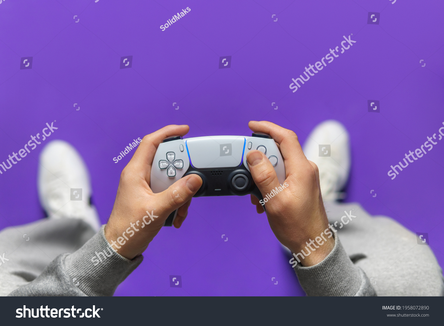 Hand hold new joystick. Gamer play game with gamepad controller. Gaming man holding simulator joypad. Person with keypad joystic in arms. happy to win. clenched fist. Gaming concept. #1958072890