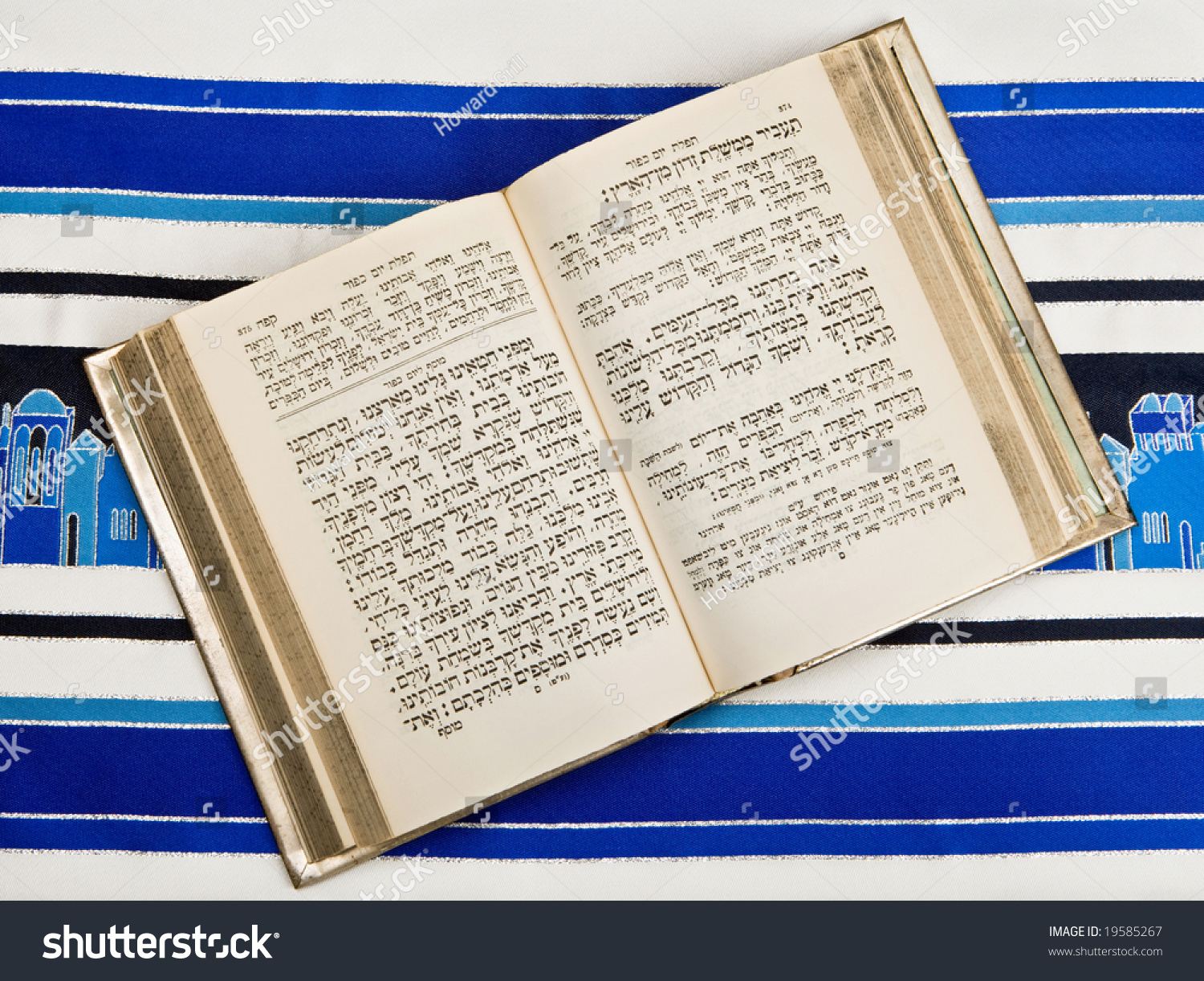 A Jewish prayer book, or Siddur, open and on top of a Jewish prayer shawl or Tallit. #19585267