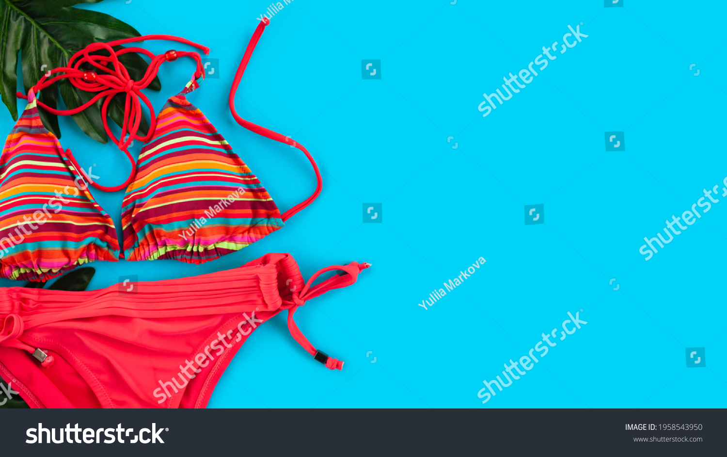 Female red swimsuit on blue background . Summer vacation concept. Flat lay. Top view. Copy space. #1958543950