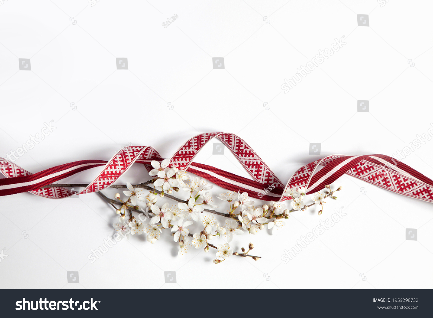 Latvian national celebration decoration with a flourishing branch made of Latvian flag ribbon and Lielvarde belt ribbon for independence day of Latvia #1959298732