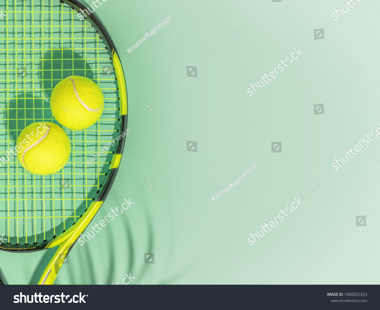 Tennis. Spring sport composition with yellow tennis ball and racket on a green background of tennis court with copy space. Sport and healthy lifestyle. The concept of outdoor game sports. Flat lay #1960025323