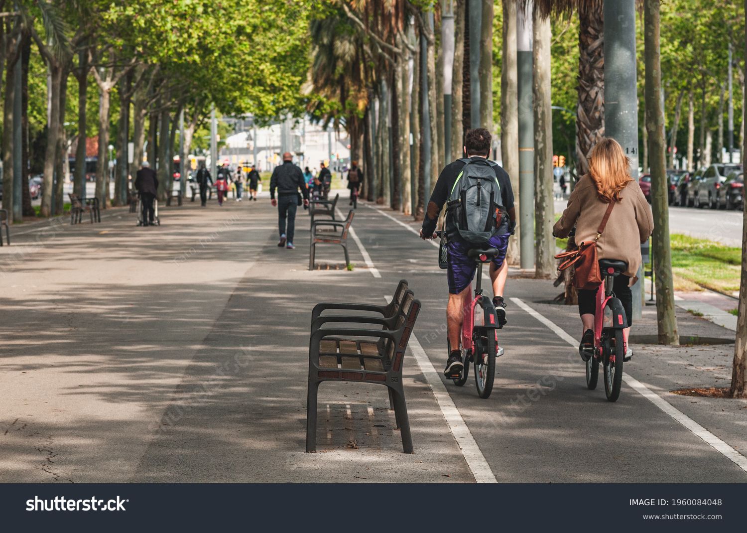 People on streets living and doing normal live in city biking sitting and walking on pedestrian way #1960084048