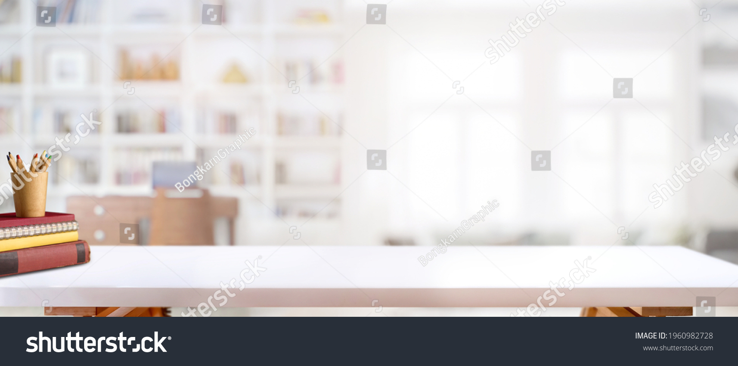 Cropped shot of white table with books, stationery and copy space in blurred study room #1960982728