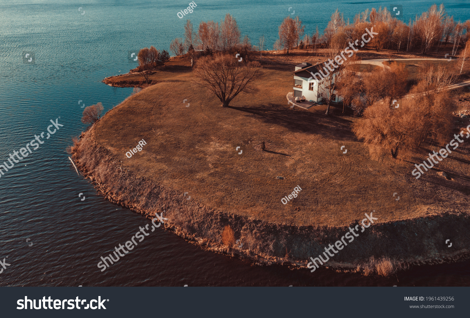View on red holiday cabin by a lake in Stockholm archipelago, Sweden. Wooden cottage, sauna on shore. Tiny house near the water. Rocky small island, islet in water. Buildings surrounded by green trees #1961439256