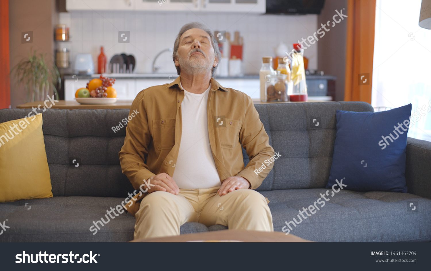 Breathing deeply at home, the old man breathes peacefully and yawns. Breath at home concept. Breath and peace concept.Peaceful home concept.  #1961463709