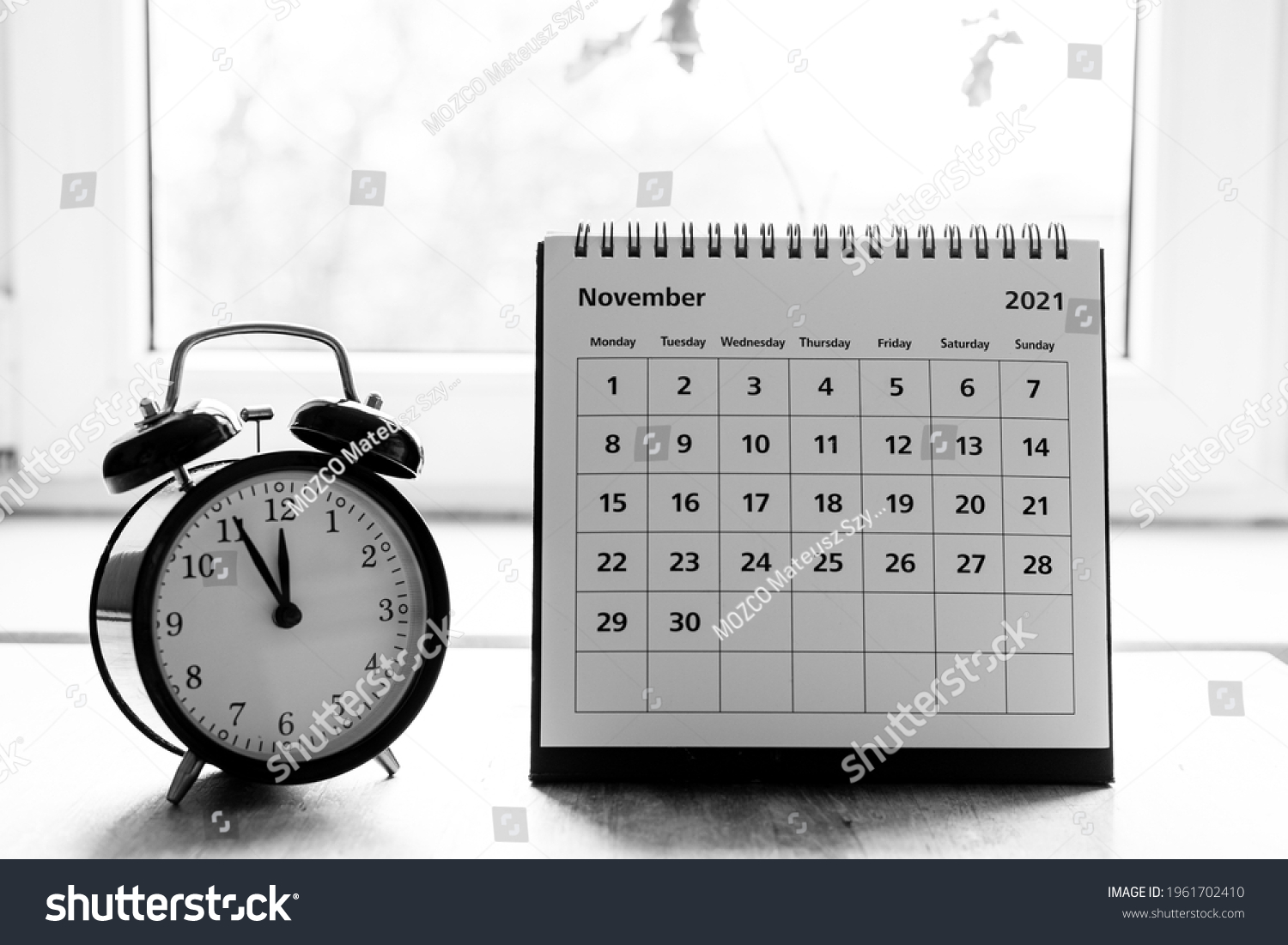 November 2021 grayscale calendar - month page showing date on wooden table #1961702410