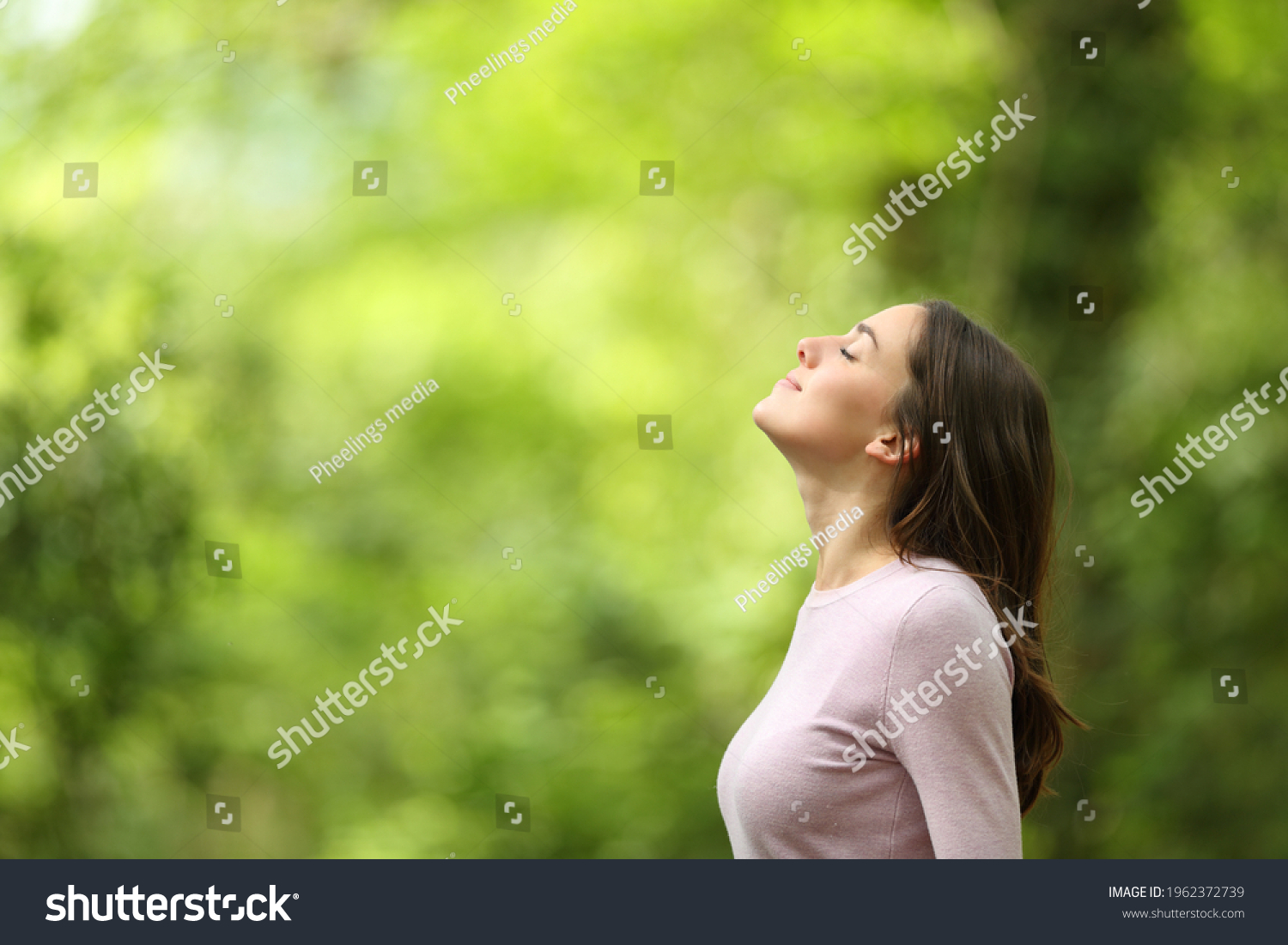 Profile of a relaxed woman breathing fresh air in a green forest #1962372739