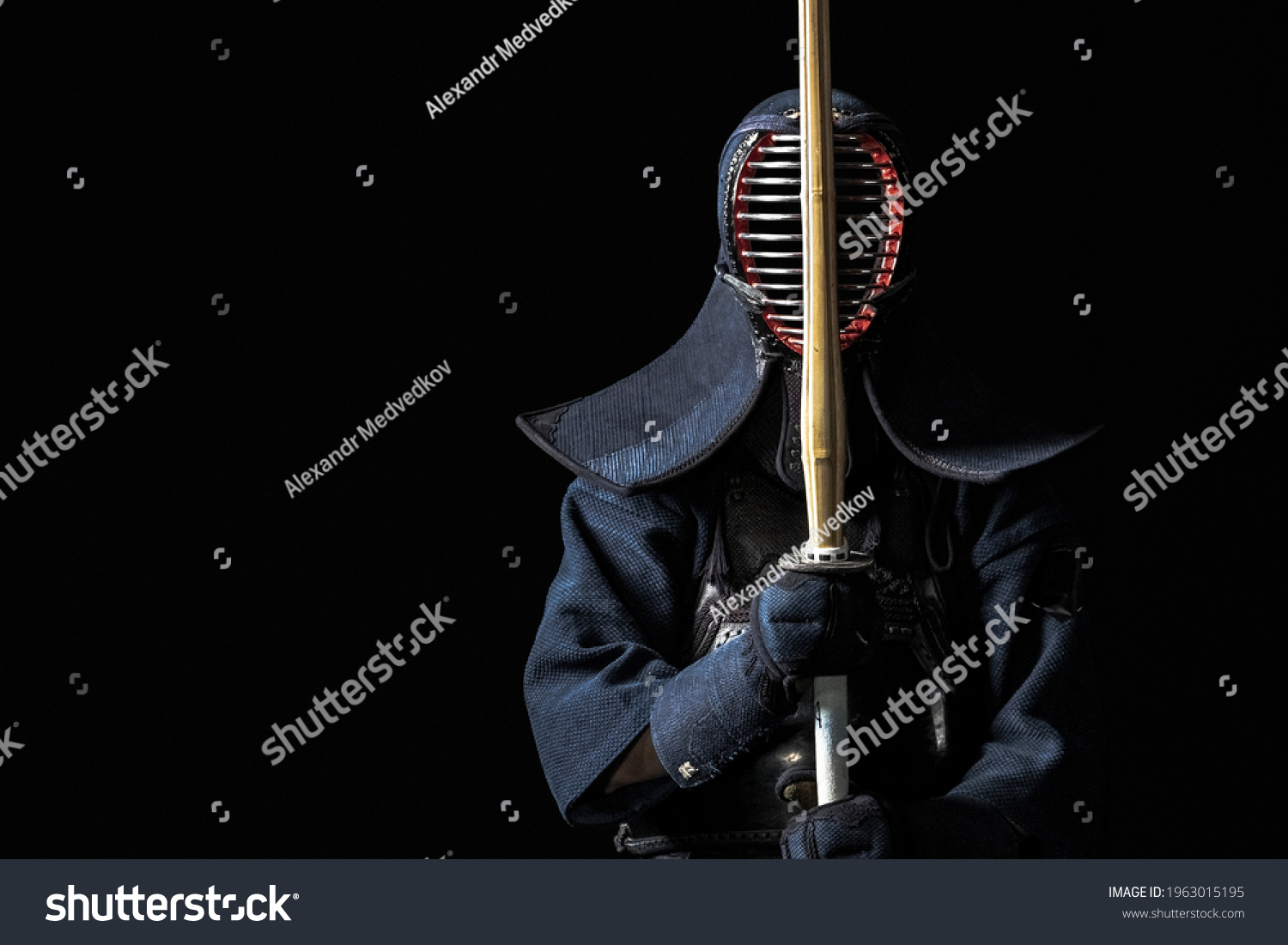 Japanese kendo fighter with with shinai on a black background #1963015195