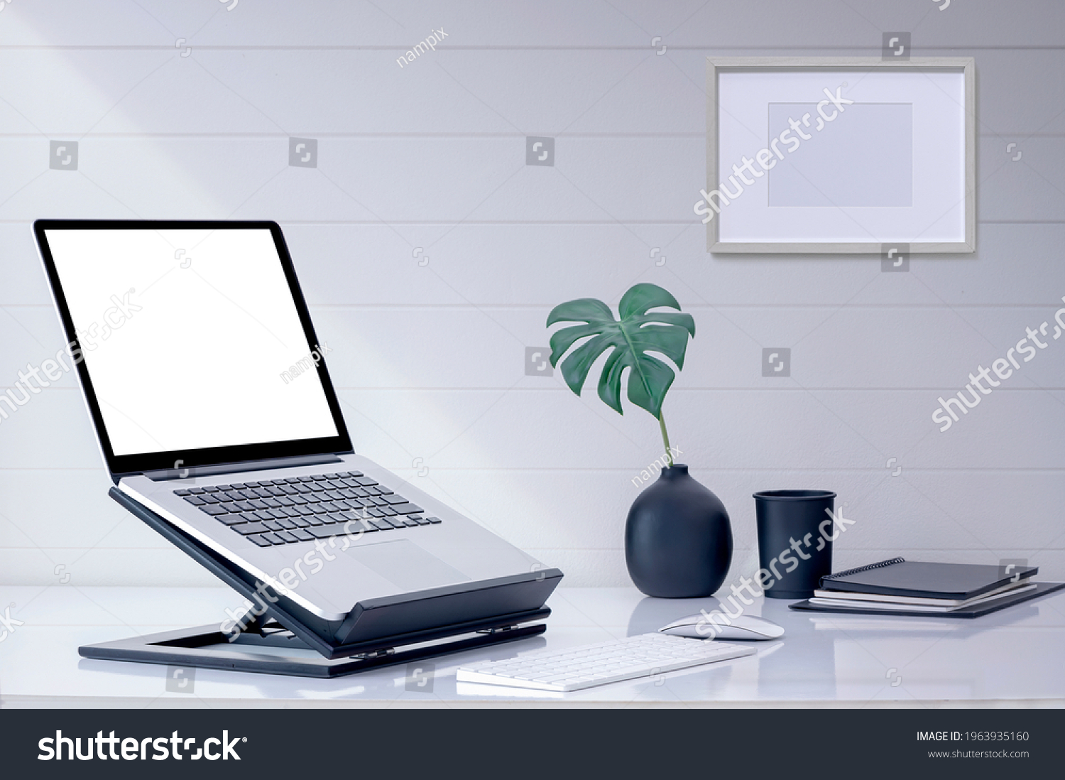 Mockup blank screen laptop computer on wooden stand with keyboard and mouse on white top table. #1963935160