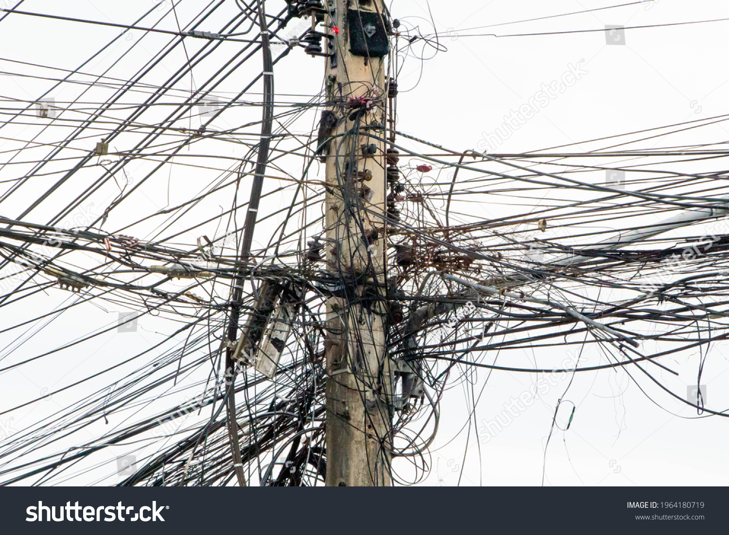 messy electricity wires on the pole, The chaos of cables and wires on an electric pole in Thailand #1964180719