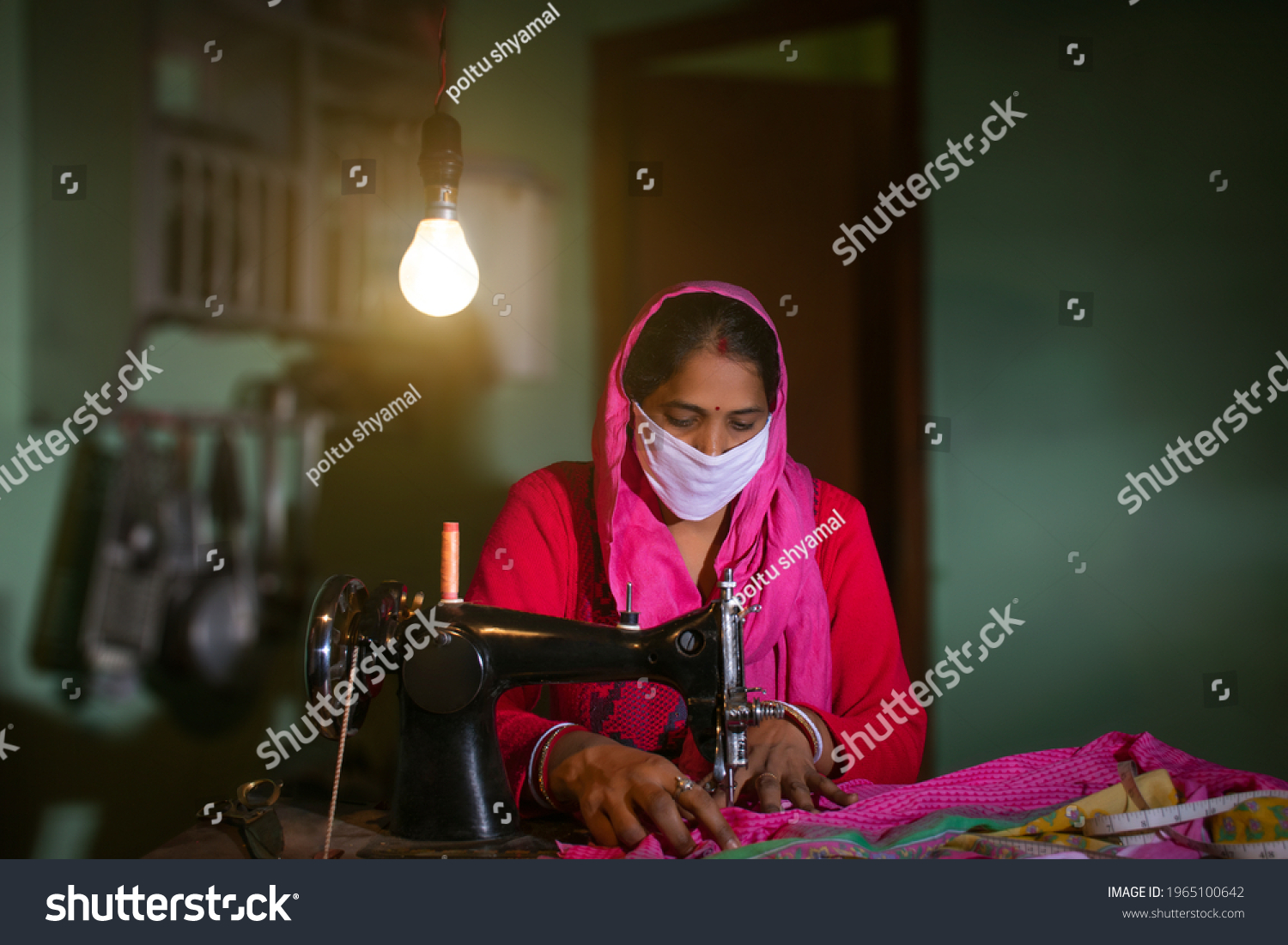 PORTRAIT OF A RURAL WOMAN WEARING MASK AND SEWING CLOTHES
 #1965100642