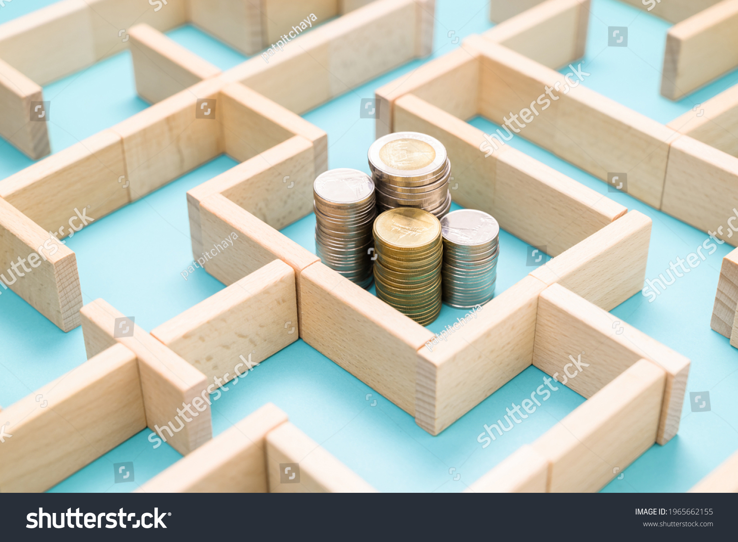 Group of coins heaps in the maze game built by wood blocks, find a way to money resource, business budget, making money concept #1965662155