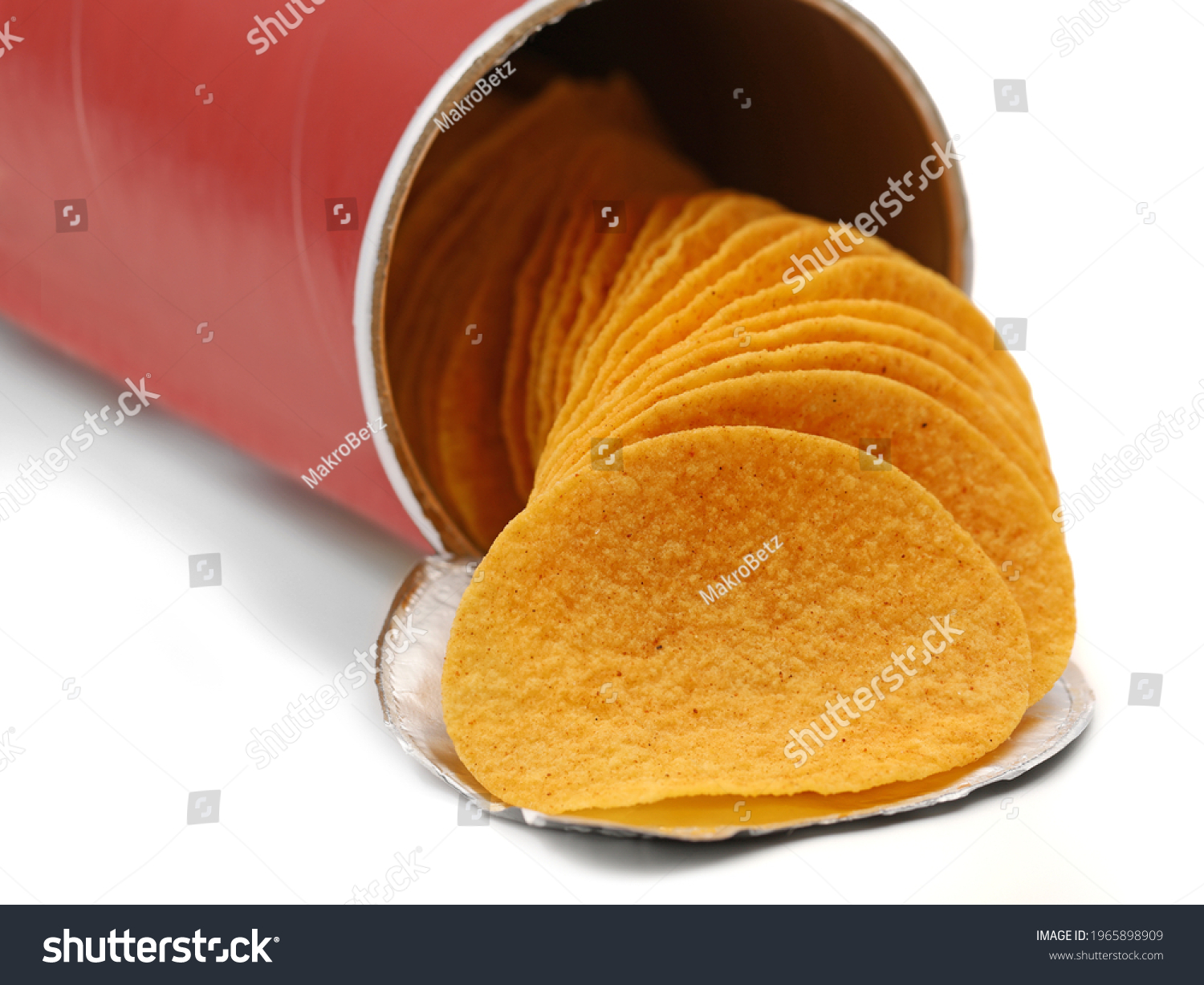 stacked crisps falling out from red cardboard tube, paprika flavoured potato chips in can isolated on white background #1965898909
