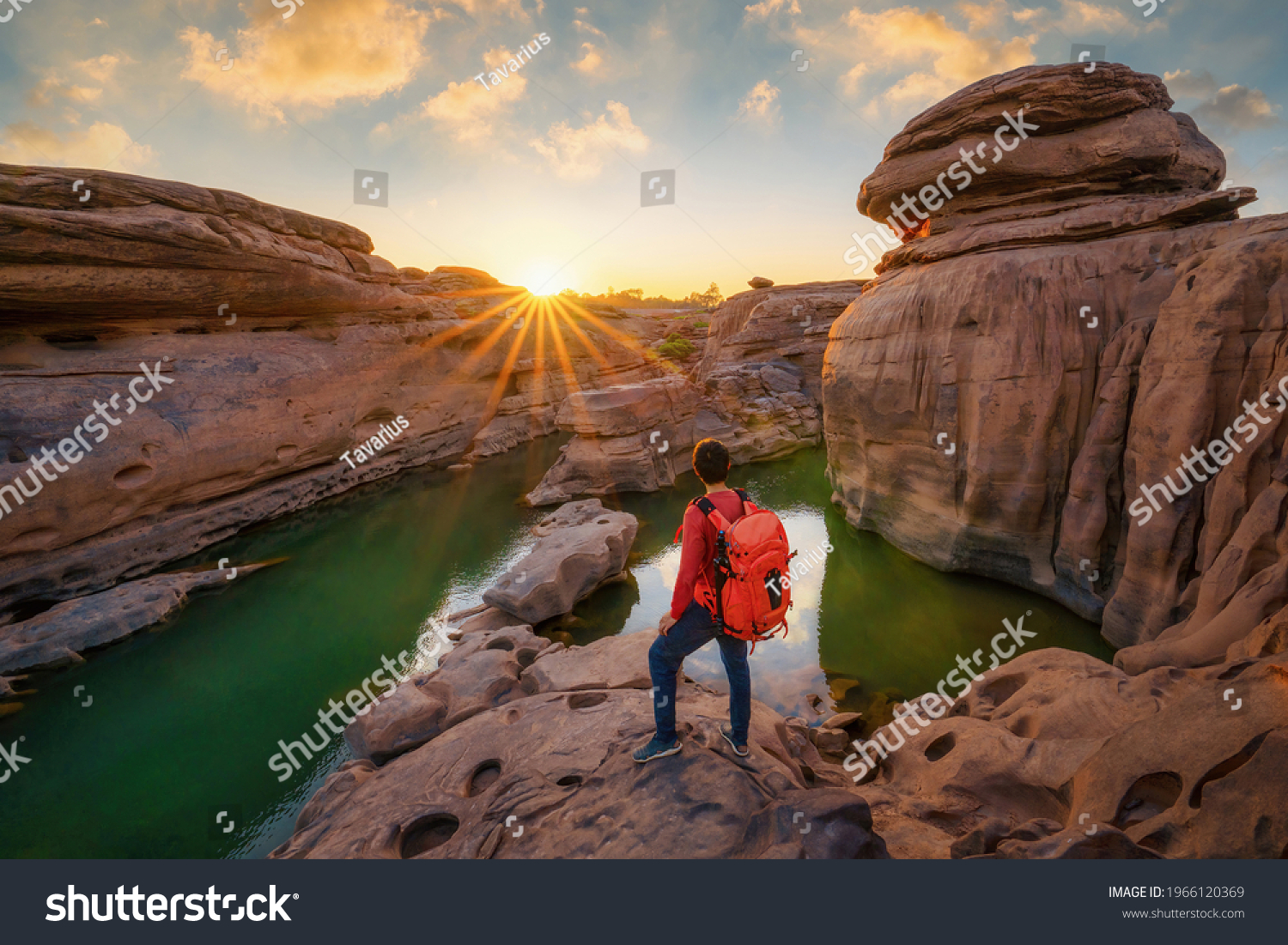 Back of tourist man, a backpacker people, travel in Sam Phan Bok, Ubon Ratchathani, Thailand. Dry rock with mountain hills. Nature landscape. Grand Canyon of Thailand. Adventure lifestyle activity. #1966120369