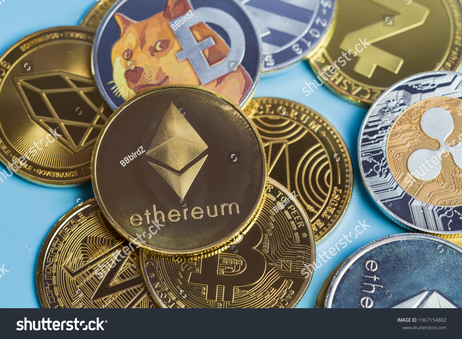 Golden Ethereum ETH group included with Crypto currency coin Dogecoin DOGE, bitcoin BTC, Binance Coin, Zcash TRON symbol Virtual blockchain technology future is money close up and Macro concept. #1967154802