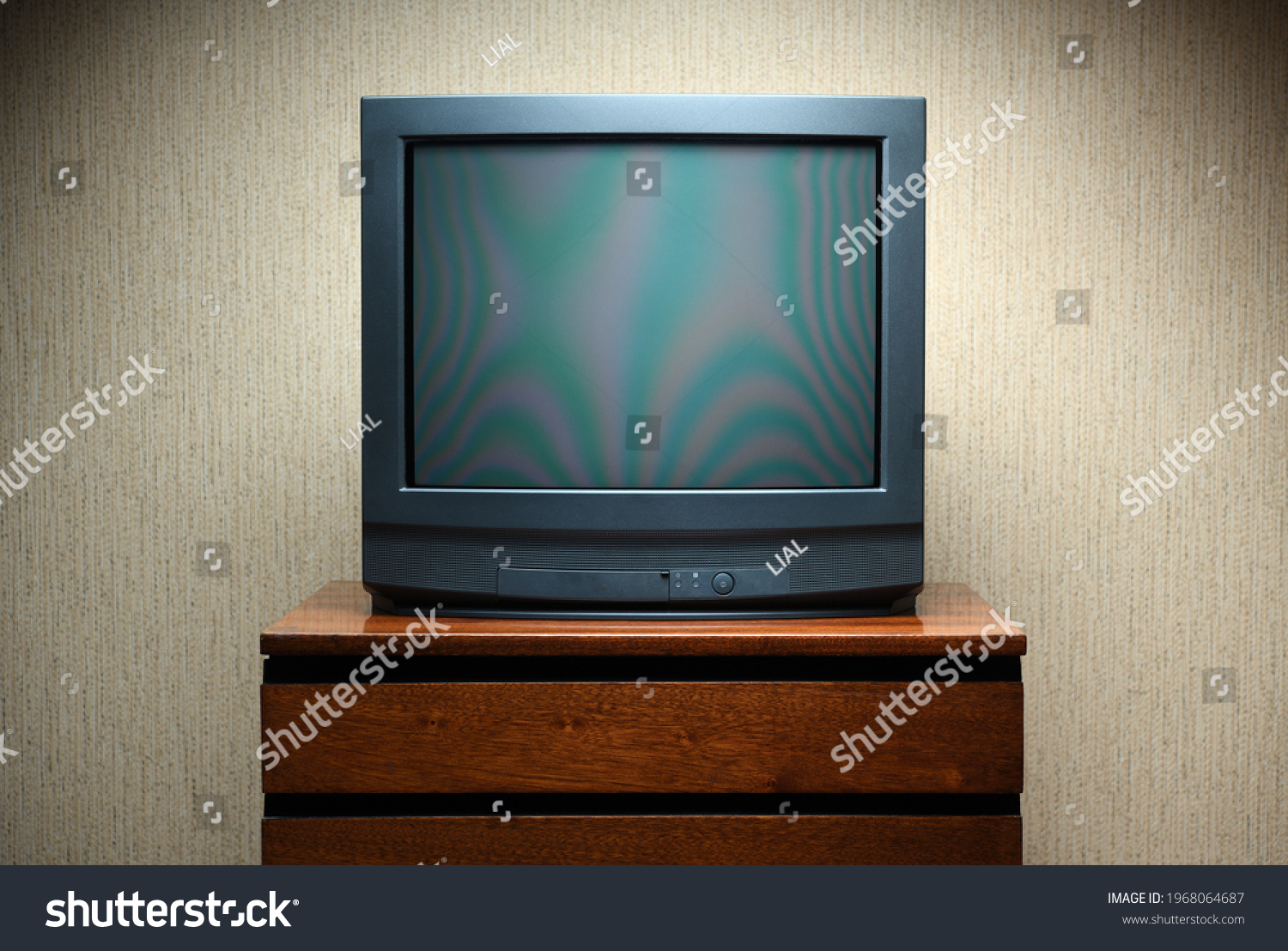 Vintage TV on wooden antique closet, old design in a home.Old black vintage TV. #1968064687