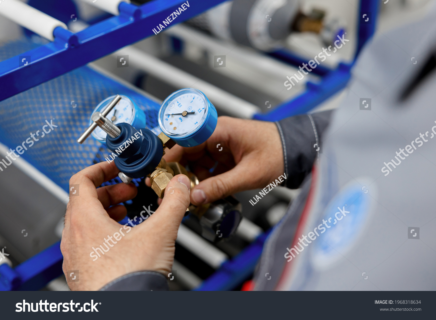 A metrology laboratory specialist takes a compressed gas cylinder for testing and verification. The man connects the pressure gauge. Analyze gas and check connections for leaks. #1968318634