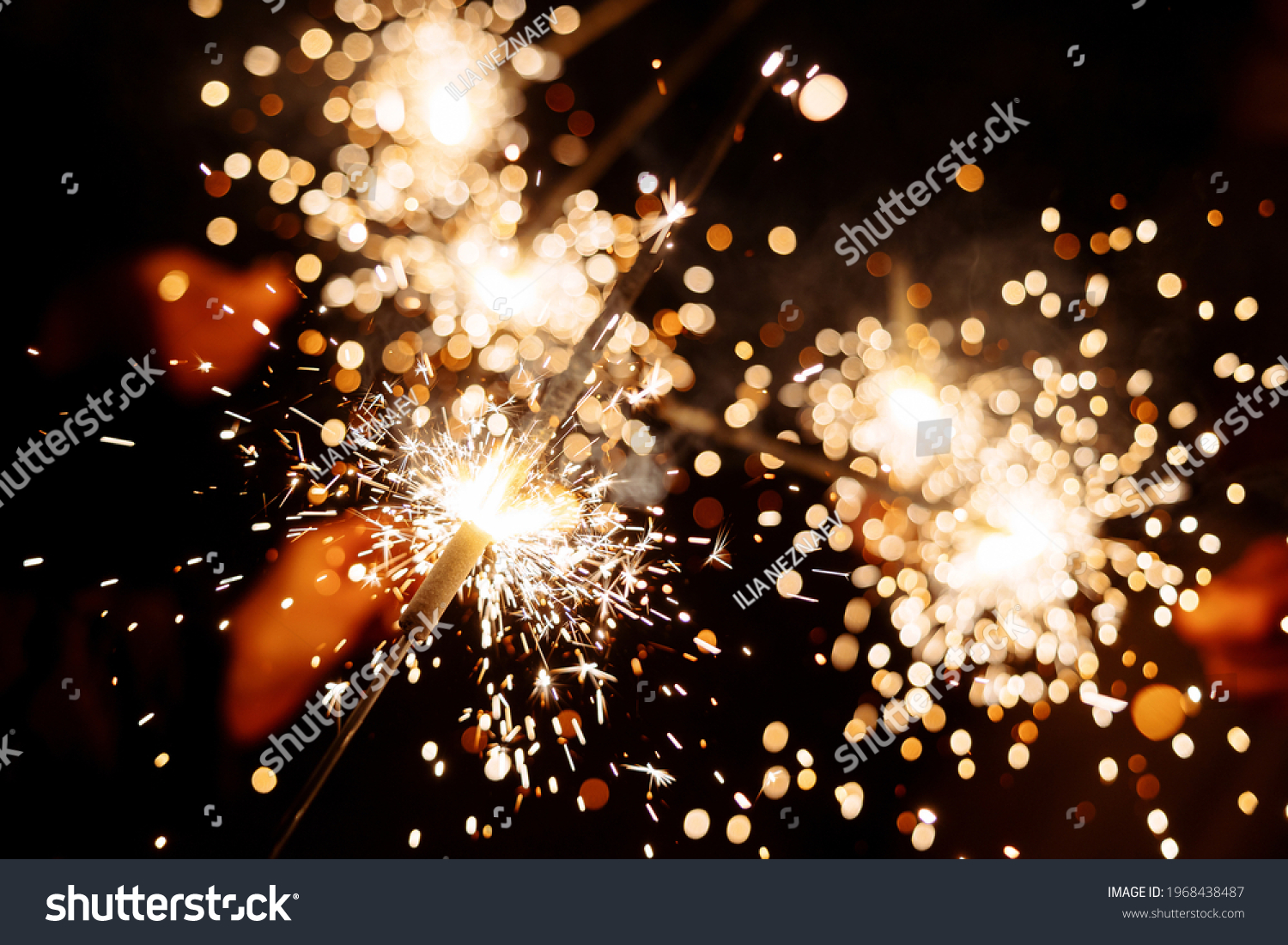 Burning fireworks and sparklers. Sparks and glare from fire flares. bengal lights #1968438487