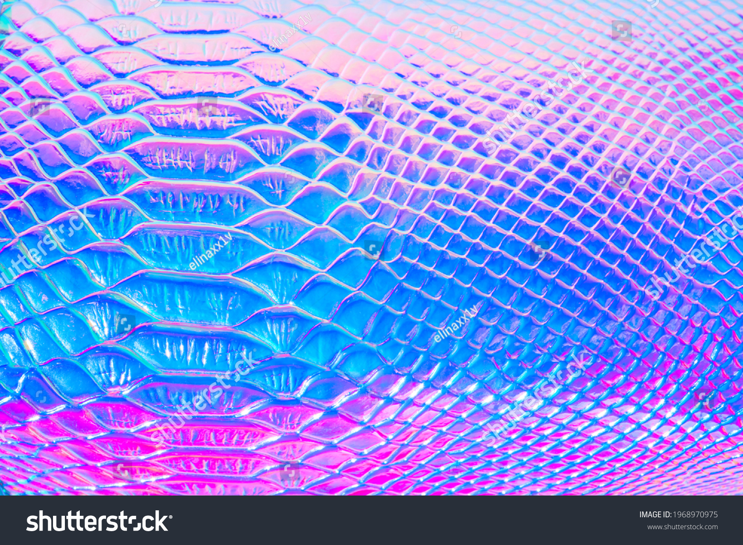 Abstract background with holographic bright rainbow multicolor. Metallized macro close up. Imitation of rainbow color. Background with a reptile skin texture in pink and blue toned. #1968970975