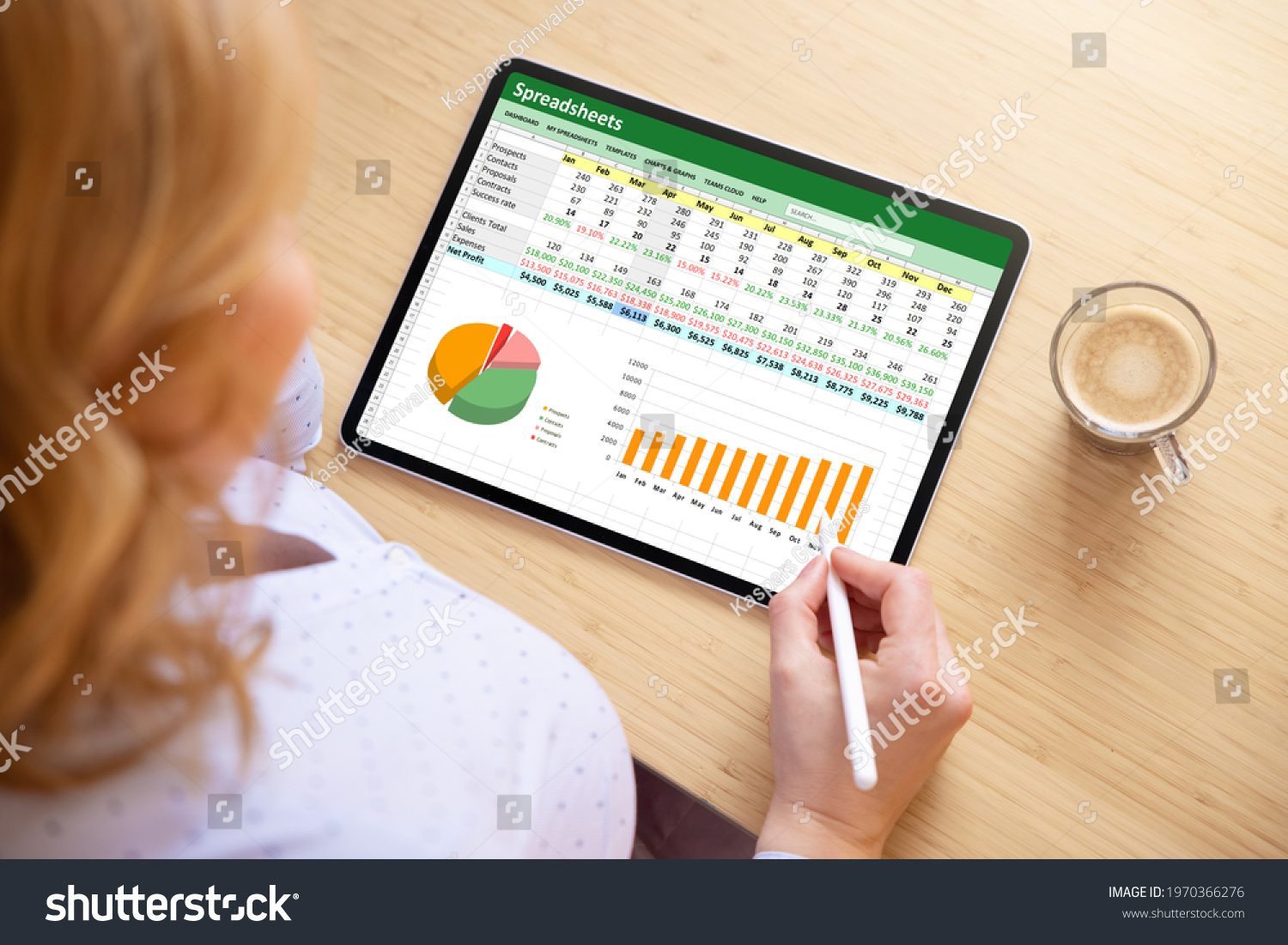 Woman working with spreadsheet document on tablet computer #1970366276