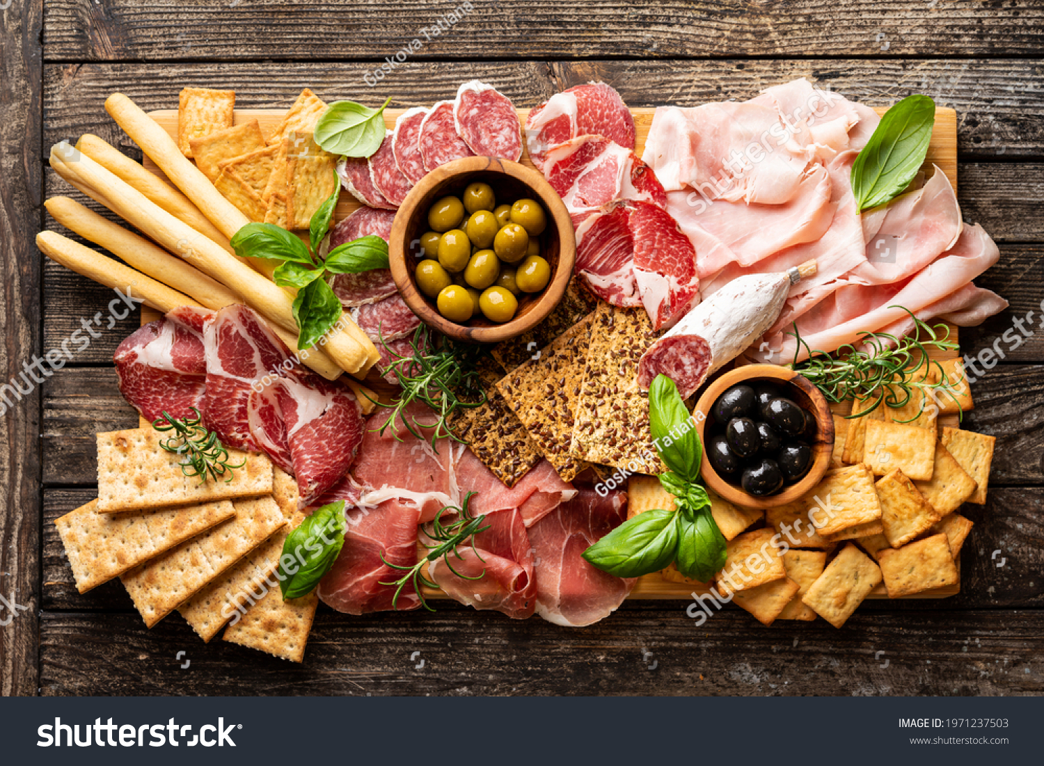Appetizers with differents antipasti, charcuterie, snacks and red wine. Sausage, ham, tapas, olives and crackers for buffet party. Top view, flat lay #1971237503