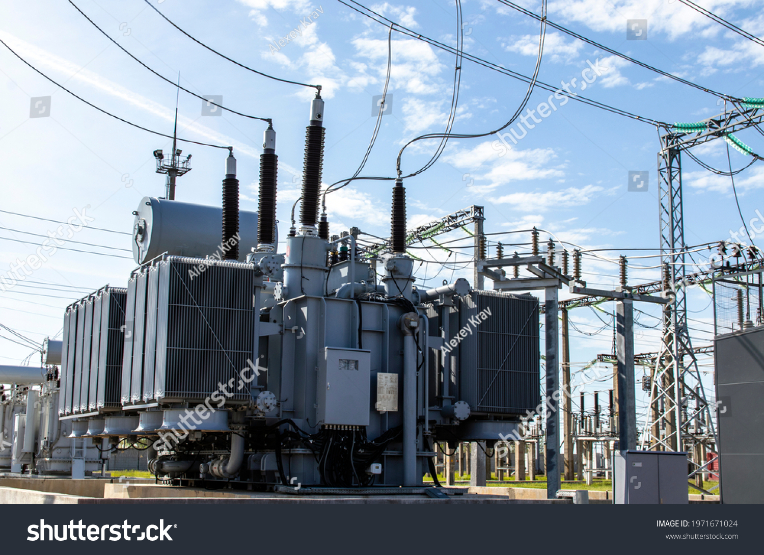 High voltage transformer against the blue sky. Electric current redistribution substation
 #1971671024