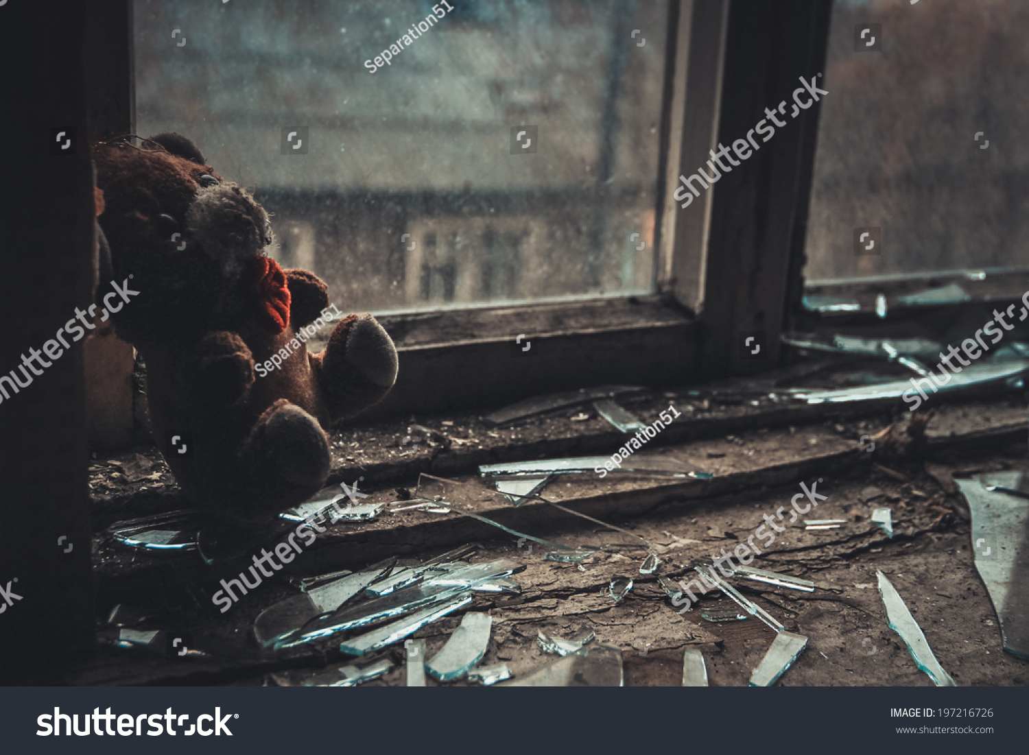 soft toy on the windowsill in the empty abandoned apartment #197216726