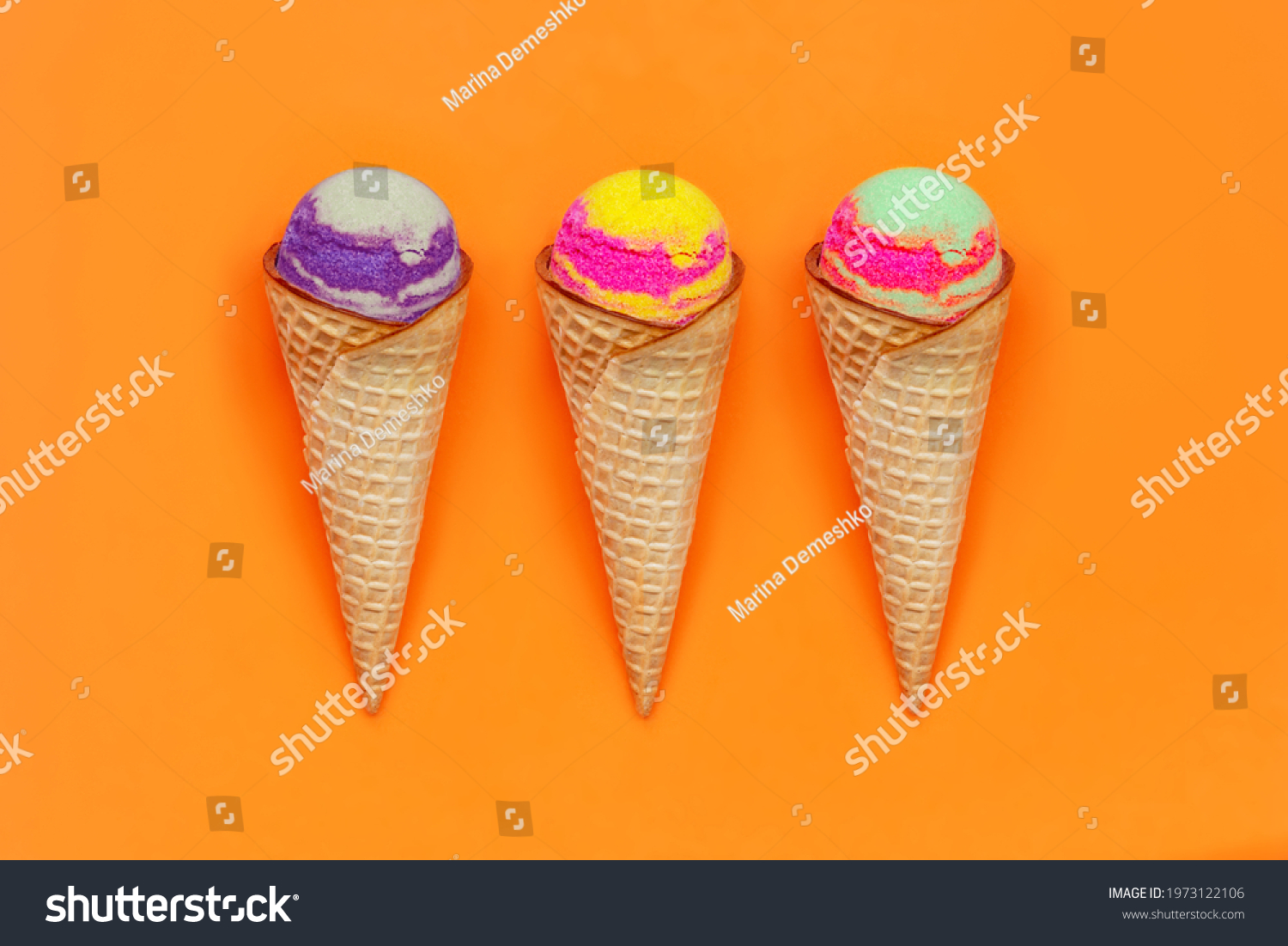 Set of three types of sweet multicolored sorbet ice-cream in a waffle cones with different fruit and berry flavors isolated on a color bright orange background. Summer concept #1973122106