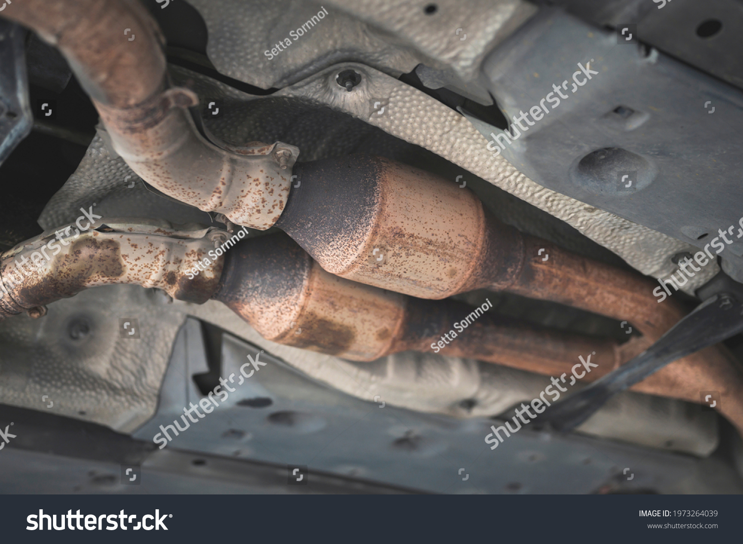 Close-up of catalytic converter in automobile exhaust system. #1973264039