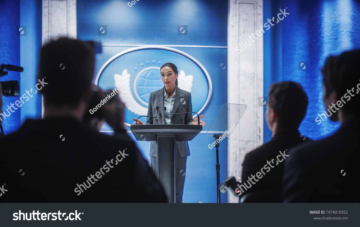 Organization Female Representative Speaking at a Press Conference in Government Building. Press Office Representative Delivering a Speech at a Summit. Minister Speaking to a Congress Hearing. #1974010352