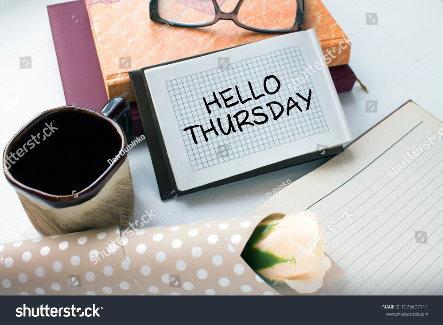 Office table with supply notepad with text Hello Thursday flower and coffe cup. Can be use as concept photo #1975607111
