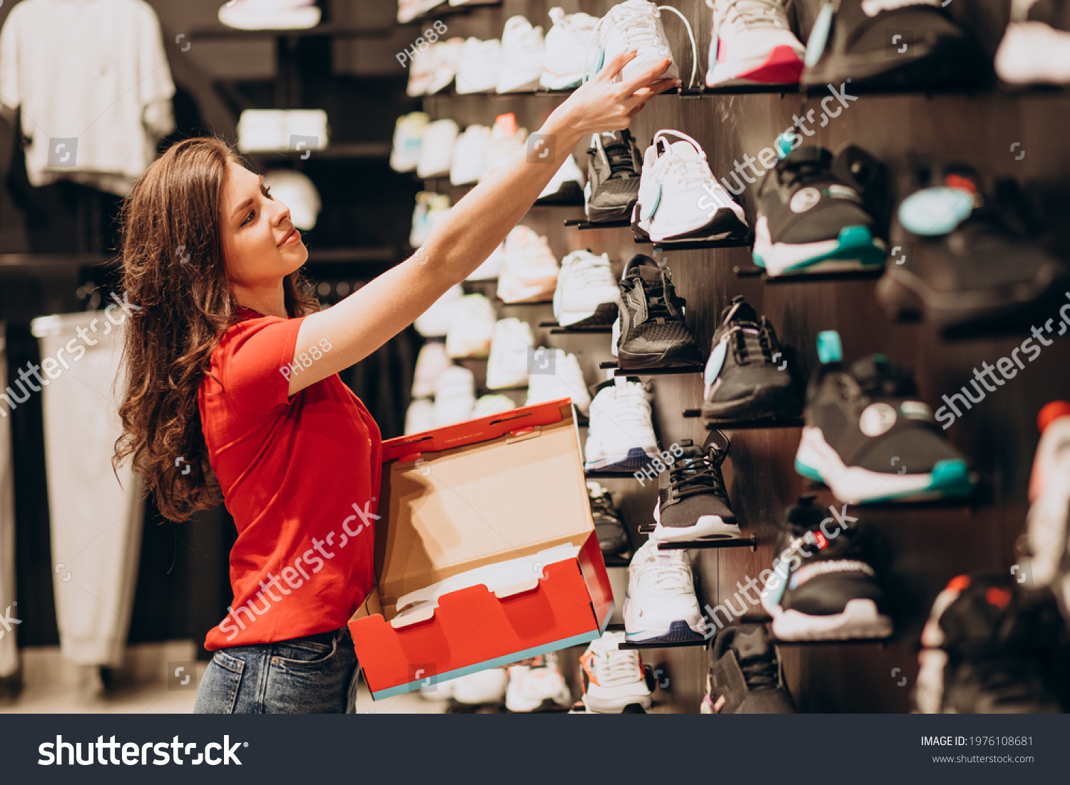 Young woman working at sportswear shop #1976108681