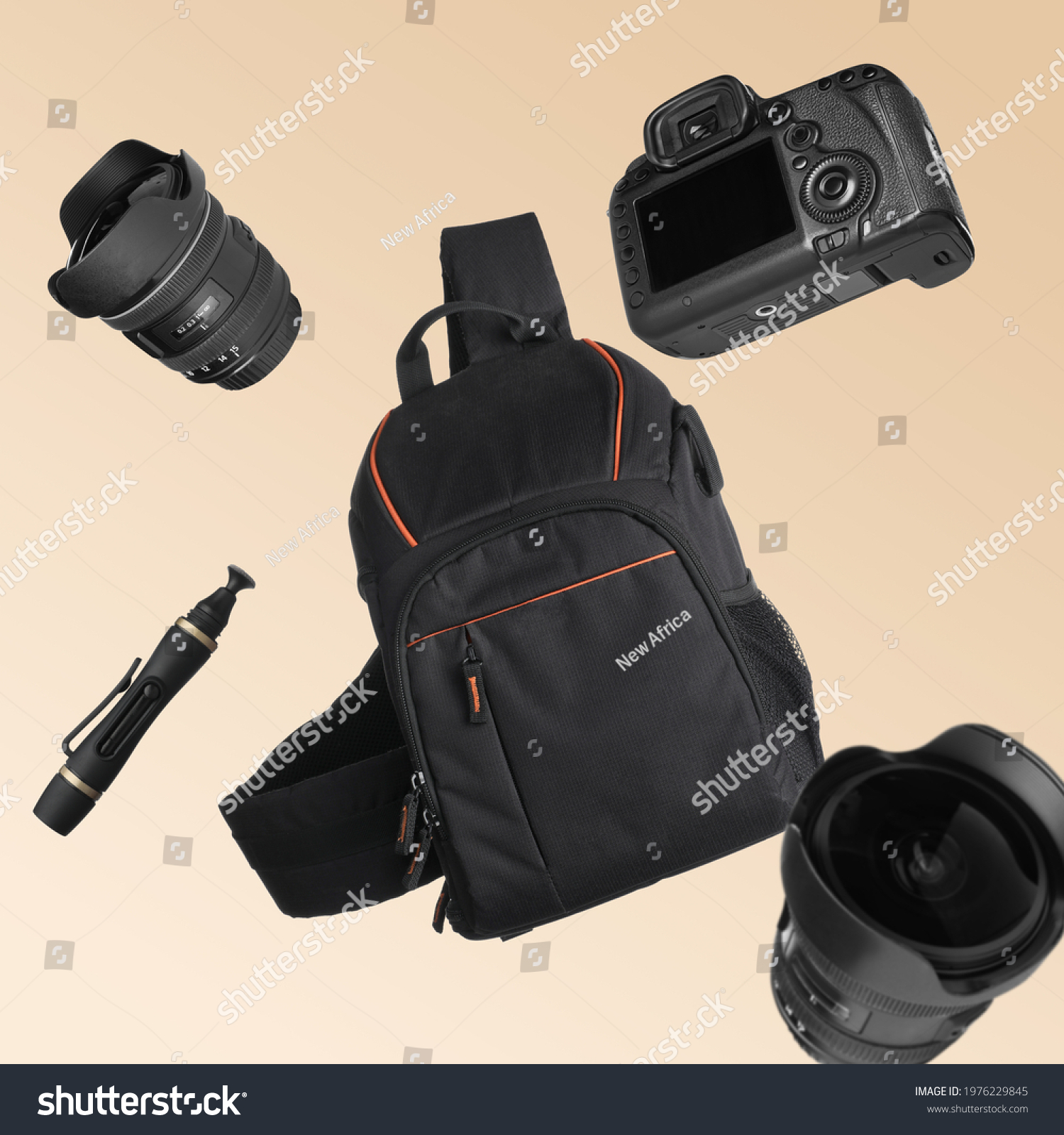 Different professional photography equipment falling on beige background #1976229845