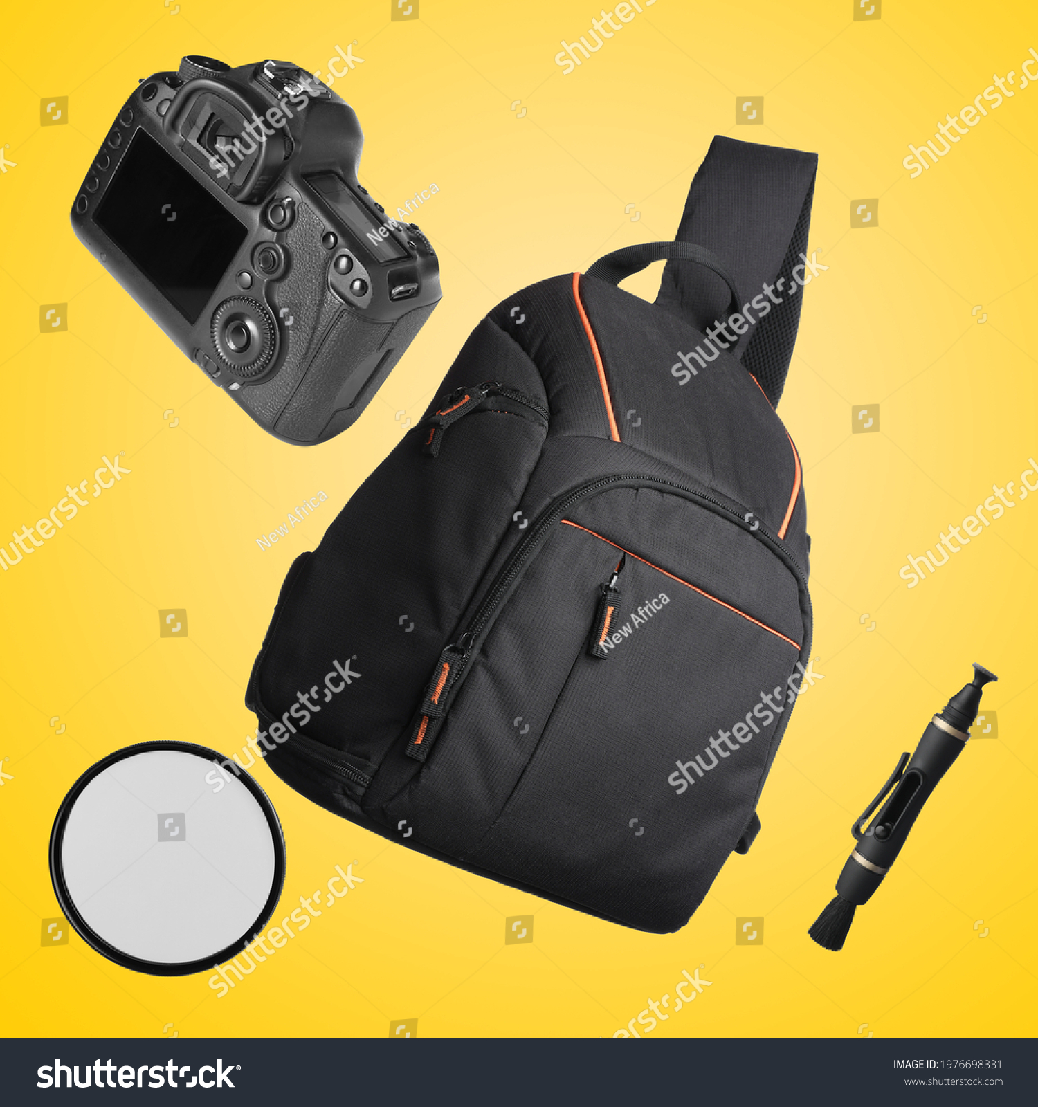Different professional photography equipment falling on yellow background #1976698331