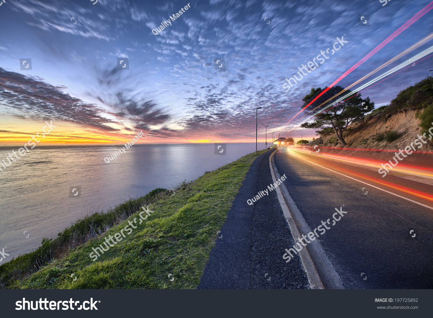 Cape Town sunset over ocean and road to the right with cars passing by shown with colorful streaks of light #197725892