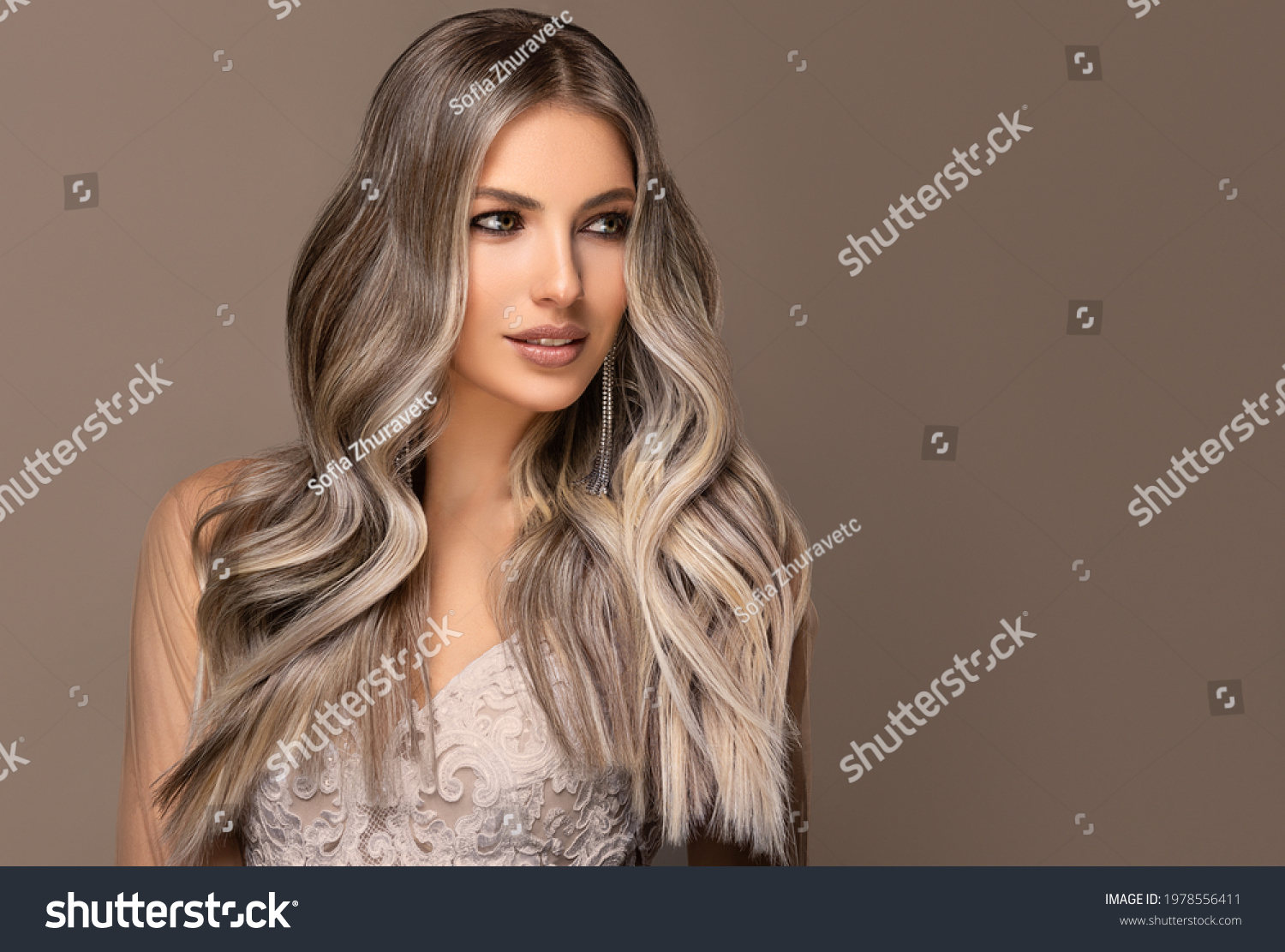 beautiful girl  hair coloring in ultra blond. Stylish hairstyle curls done in a beauty salon. Fashion, cosmetics and makeup. #1978556411