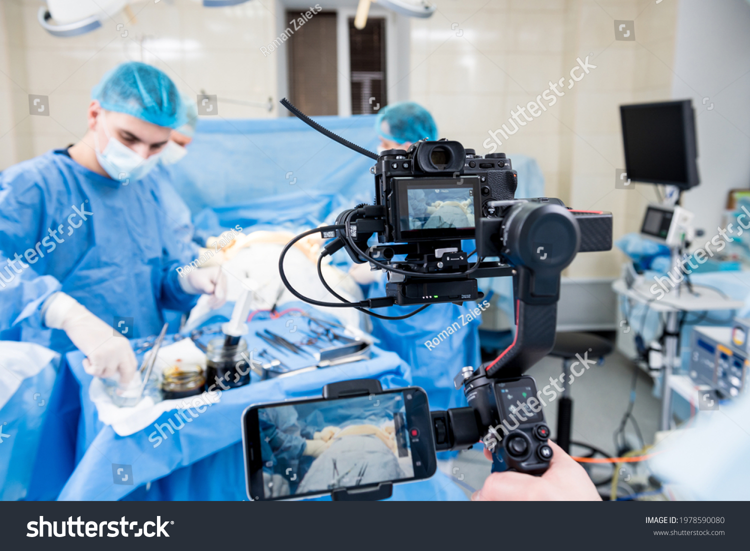 The videographer shoot the surgeon and assistants in the operating room with surgical equipment #1978590080