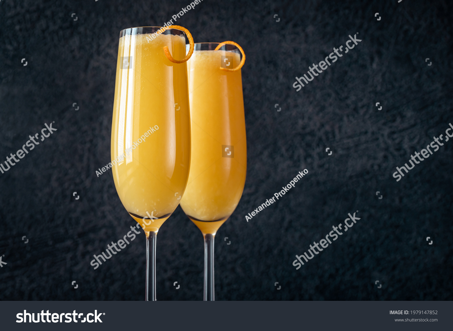 Two glasses of Buck's Fizz cocktail on black background #1979147852