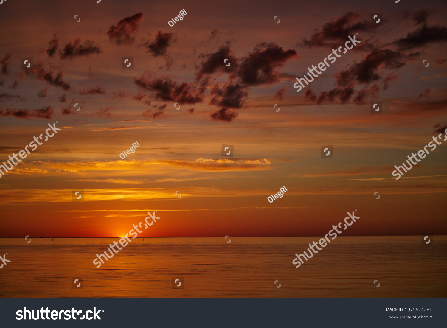 Dramatic sunset sky with clouds. Dramatic sunset over the sea #1979624261